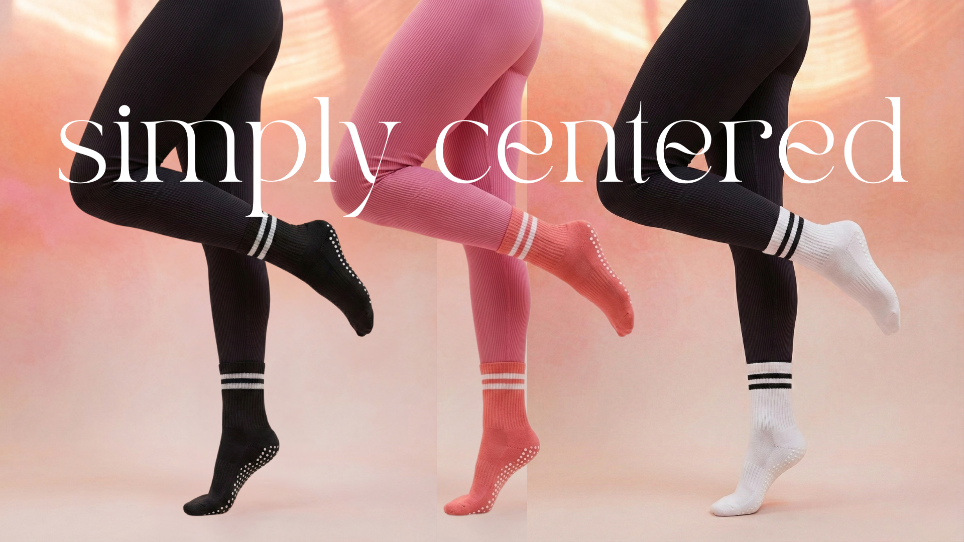 Three pairs of legs wearing black, pink, and white  non-slip pilates grip socks with striped socks on a soft pink background.