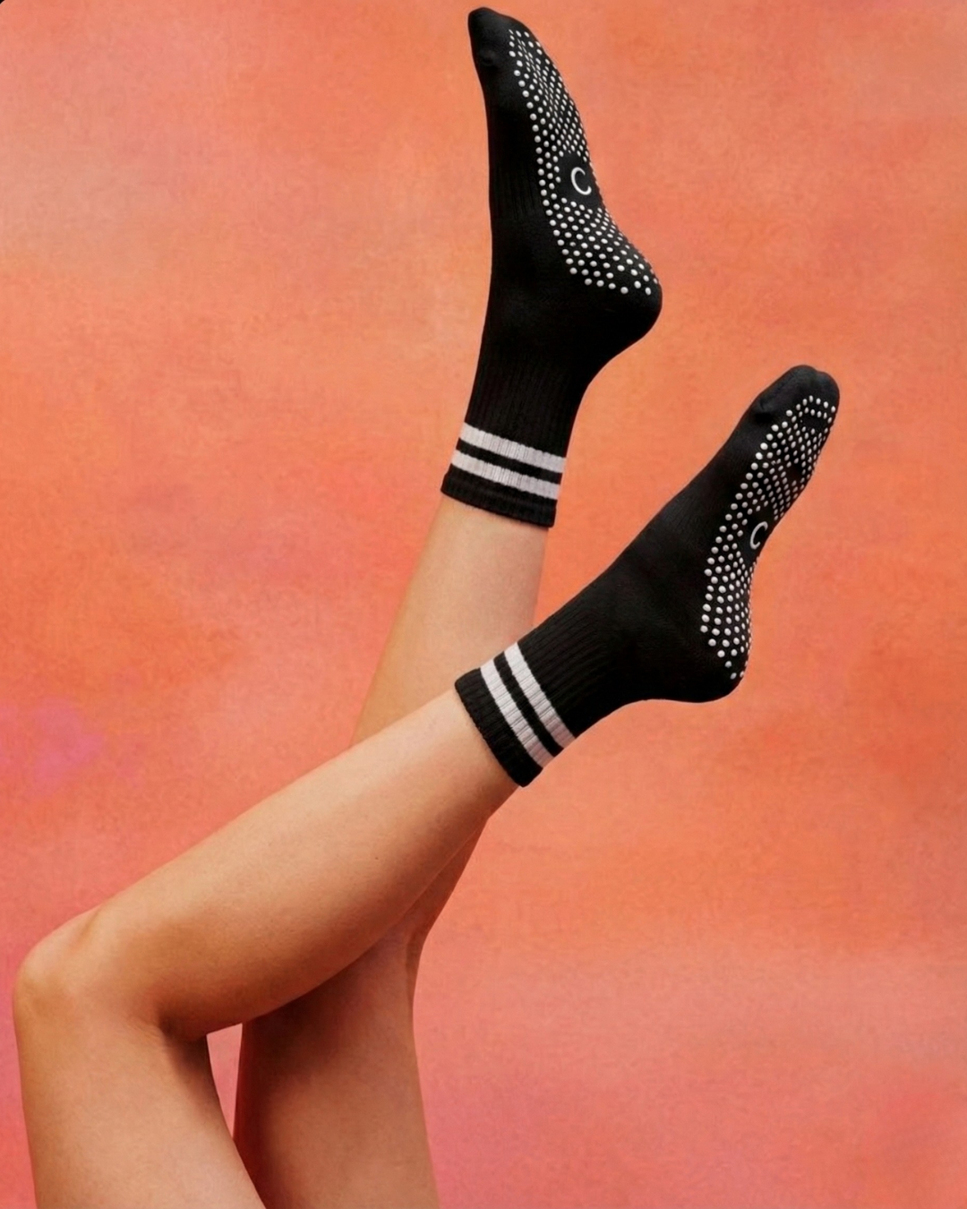Black crew pilates grip socks with white stripes Centered brand.