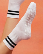White pilates grip socks sole detail with centered. logo.