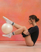centered. white anti-slip pilates grip socks pilates ball exercise.