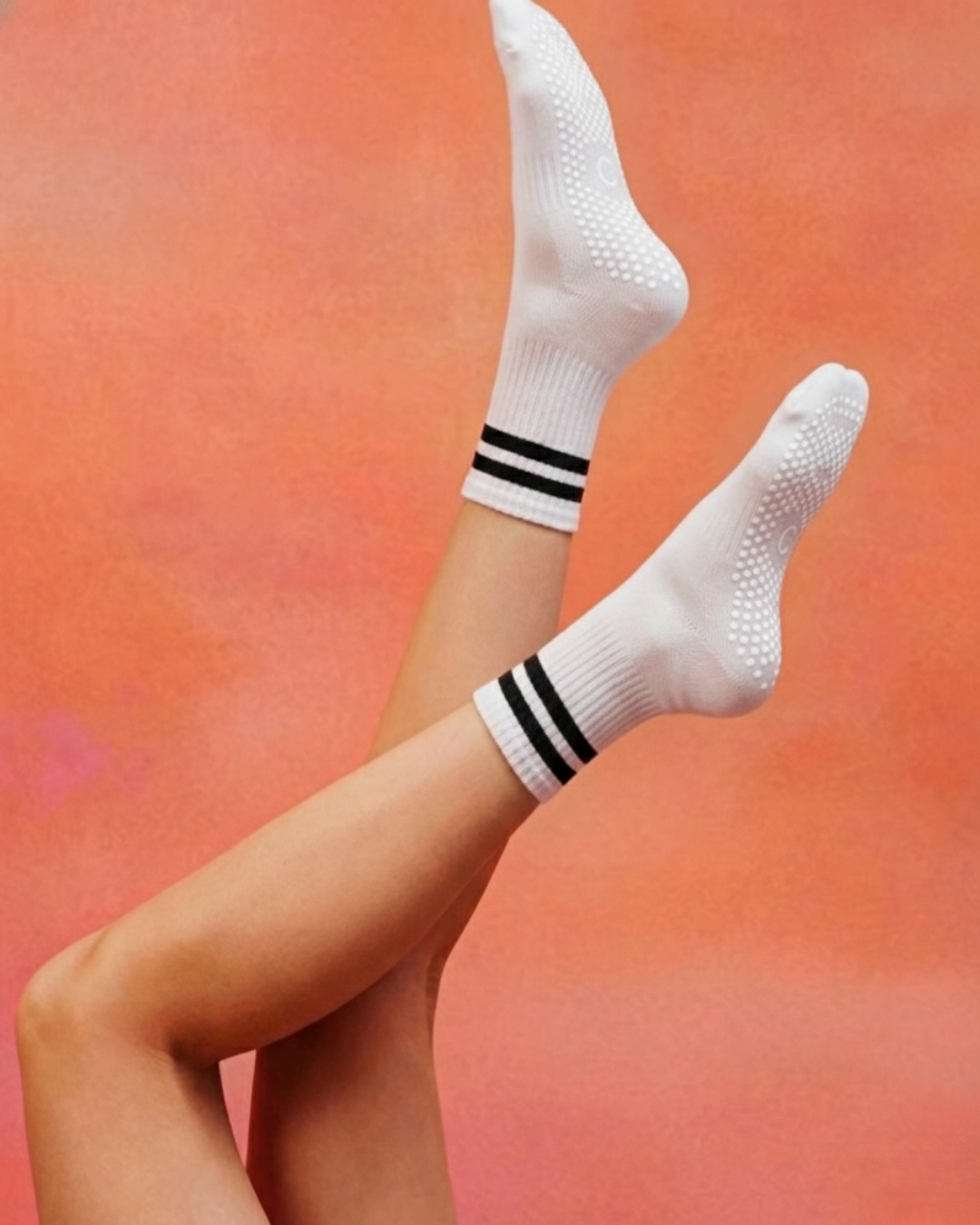 centered. brand white crew pilates grip socks with black stripes.
